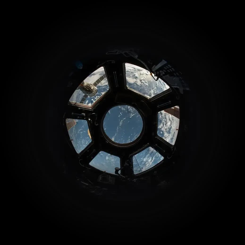 View of the Earth from the cupola of the International Space Station, showing the planet and the stars.
